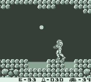 An animated GIF of Metroid II showing Samus standing motionless while a health item is showing with no animation, where it should normally be blinking.
